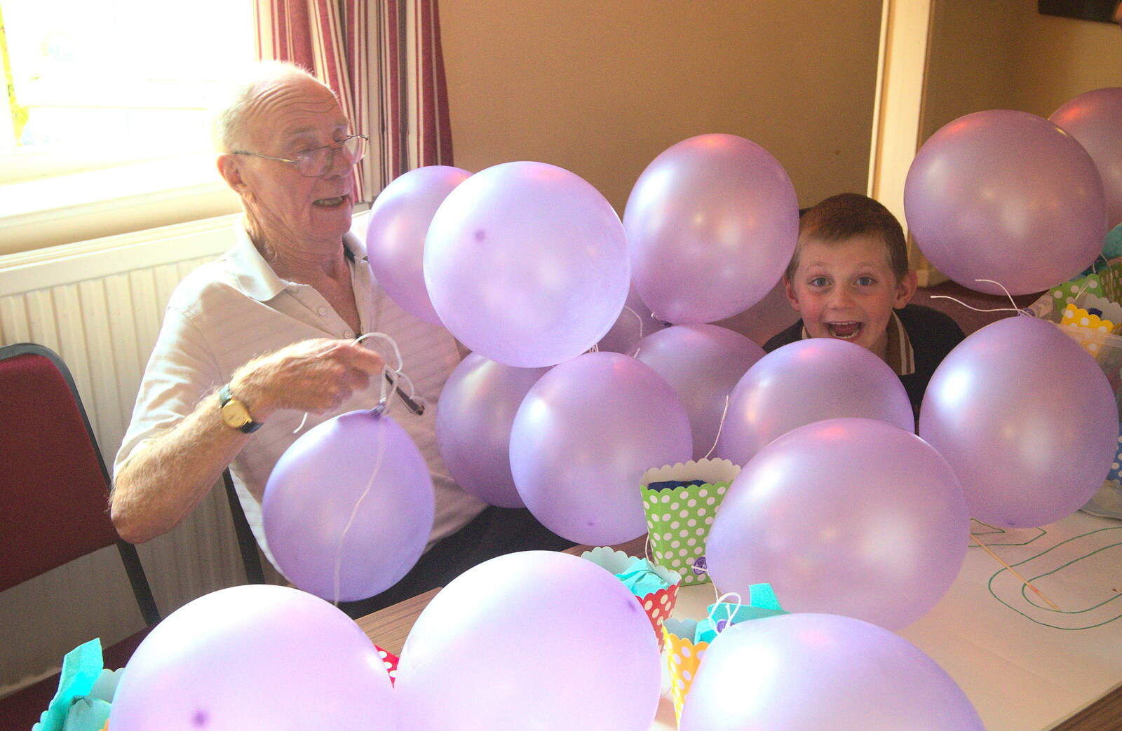 Grandad and Matthew under a pile of balloons from Fred's Fifth Birthday, The Village Hall, Brome, Suffolk - 28th September 2013
