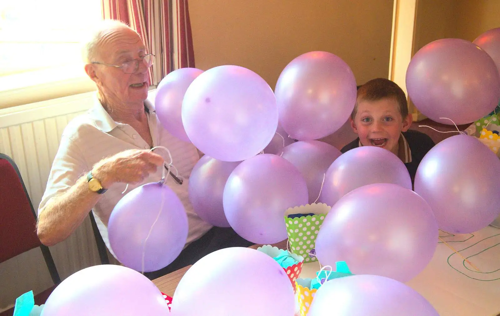 Grandad and Matthew under a pile of balloons, from Fred's Fifth Birthday, The Village Hall, Brome, Suffolk - 28th September 2013