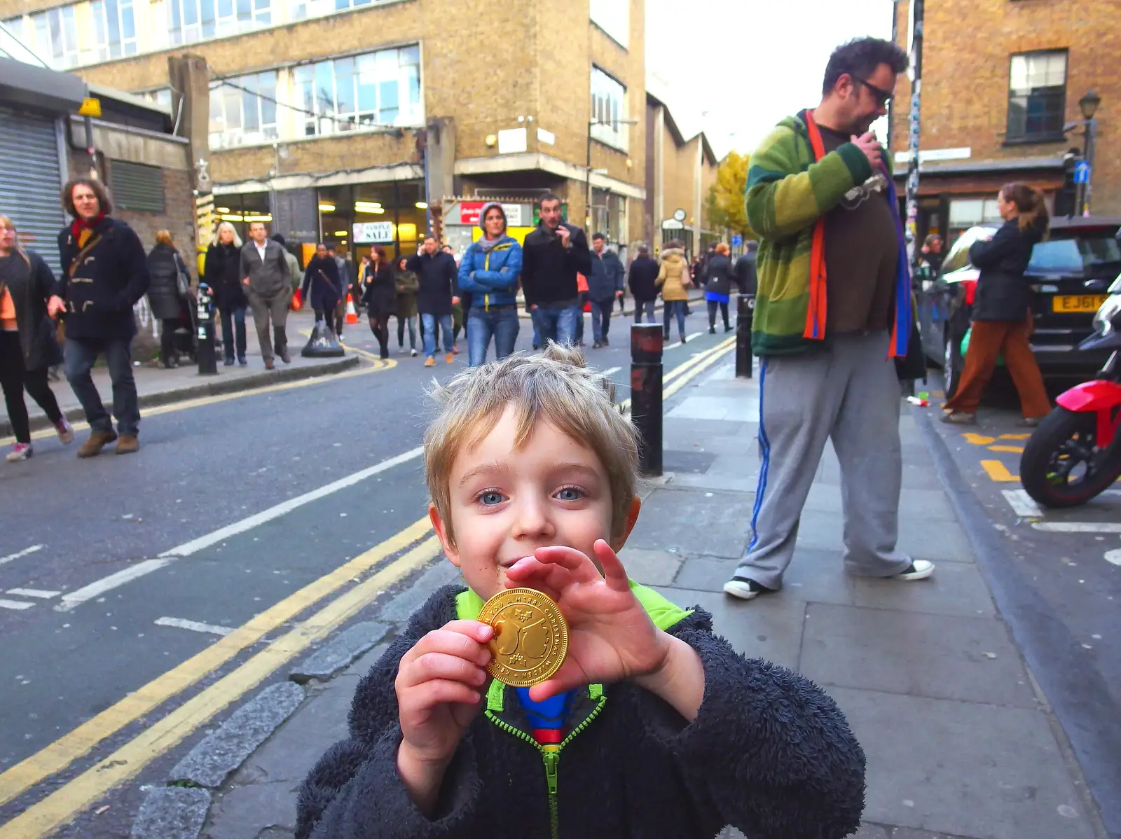 Fred shows off his shiny gold chocolate coin, from Lunch in the East End, Spitalfields and Brick Lane, London - 1st December 2013