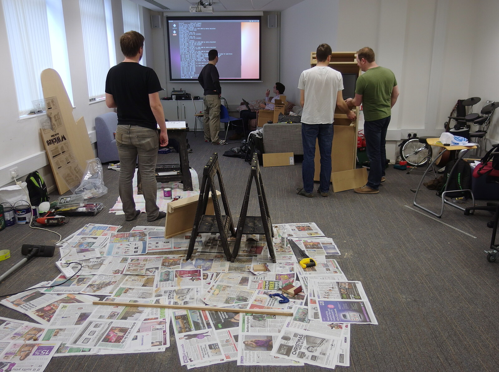 SwiftKey's Arcade Cabinet, and the Streets of Southwark, London - 5th December 2013: Newspapers are laid out for painting