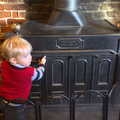 Harry pokes the wood burner, Christmas Day and all that, Brome, Suffolk - 25th December 2013