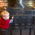 Harry pokes the wood burner, Christmas Day and all that, Brome, Suffolk - 25th December 2013