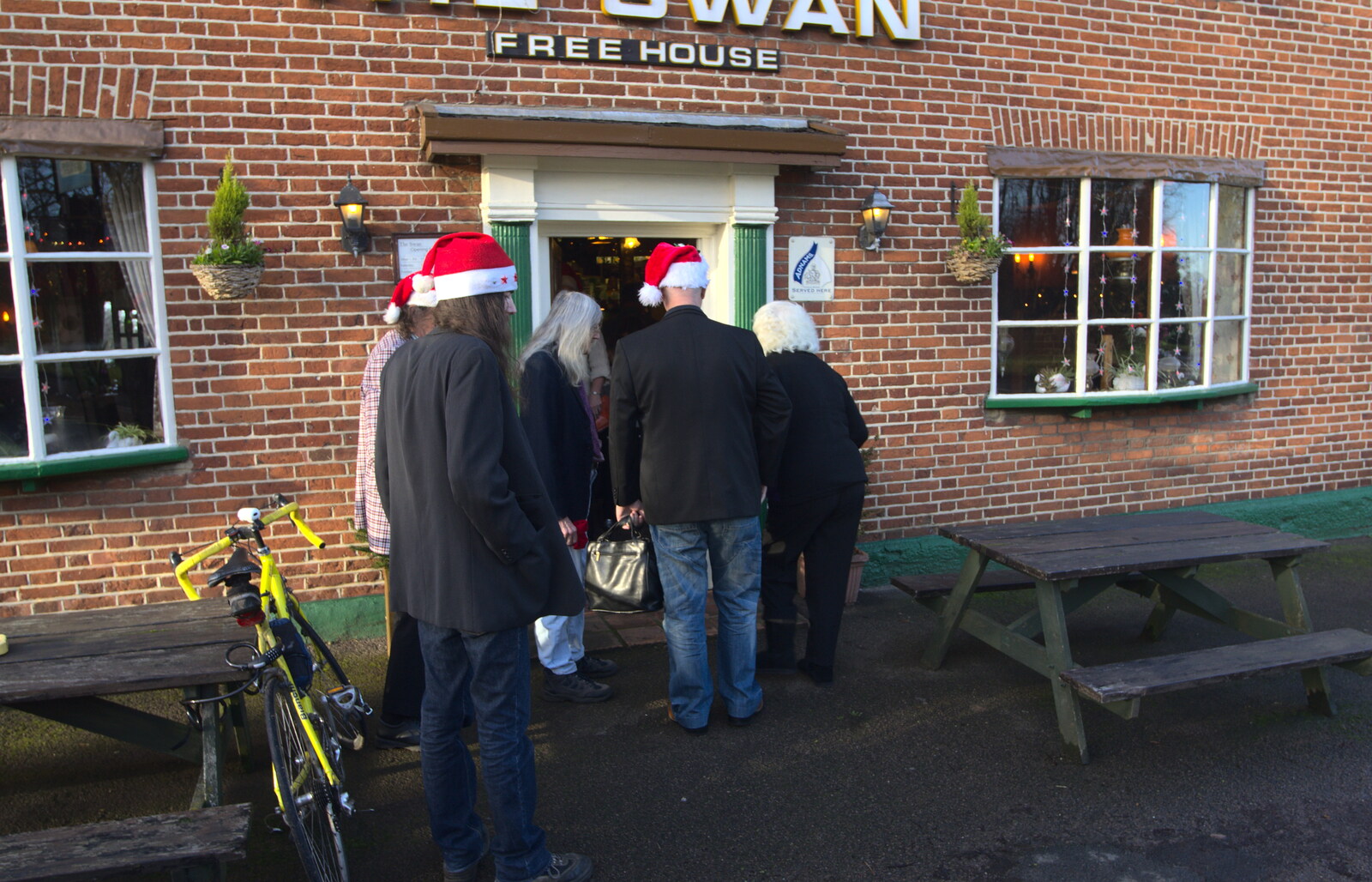 People with Santa hats on their way in from Christmas Day and all that, Brome, Suffolk - 25th December 2013