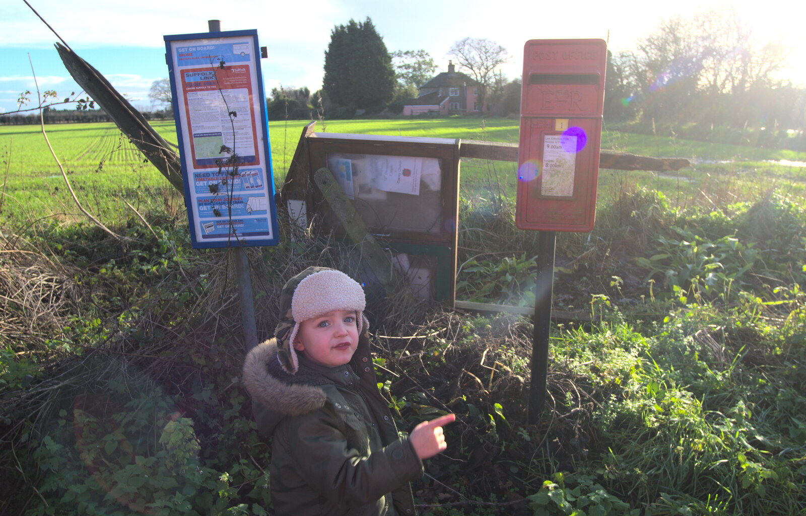 Fred points by the fallen noticeboard from Christmas Day and all that, Brome, Suffolk - 25th December 2013