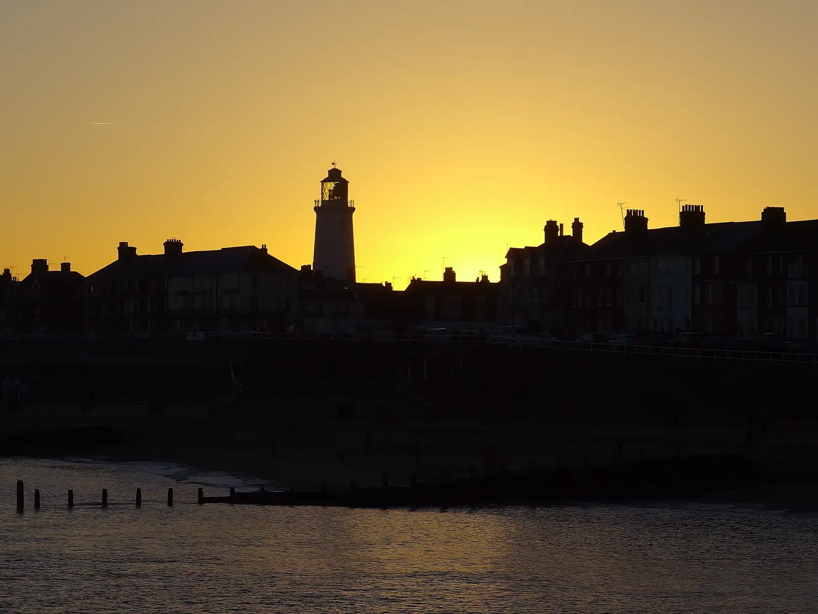 The sun sets behind the lighthouse, from Post-Christmas Southwold, Suffolk - 29th December 2013