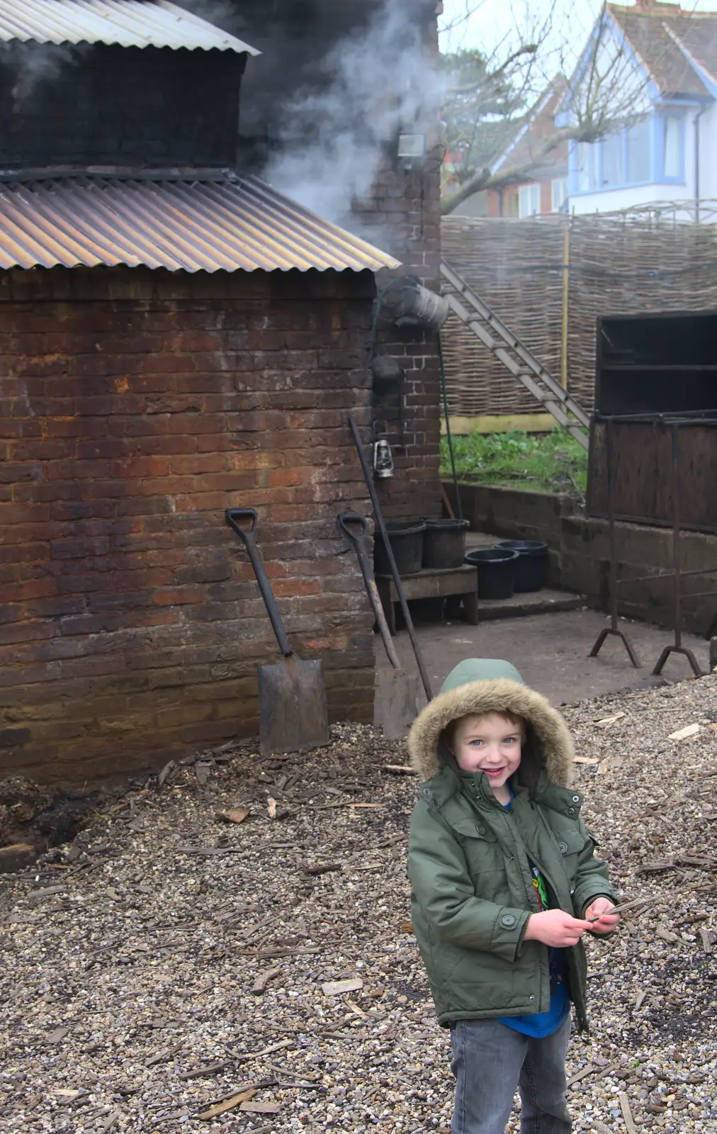 Fred in front of the smoking smokehouse, from A Trip to Orford Castle, Orford, Suffolk - 2nd March 2014