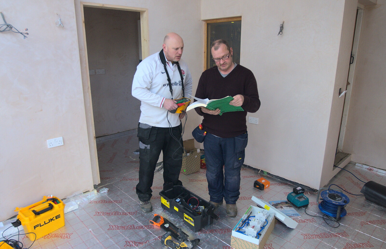 Boomer checks on the wiring regulations from Building Progress: Electrical Second Fixing, Brome, Suffolk - 4th March 2014