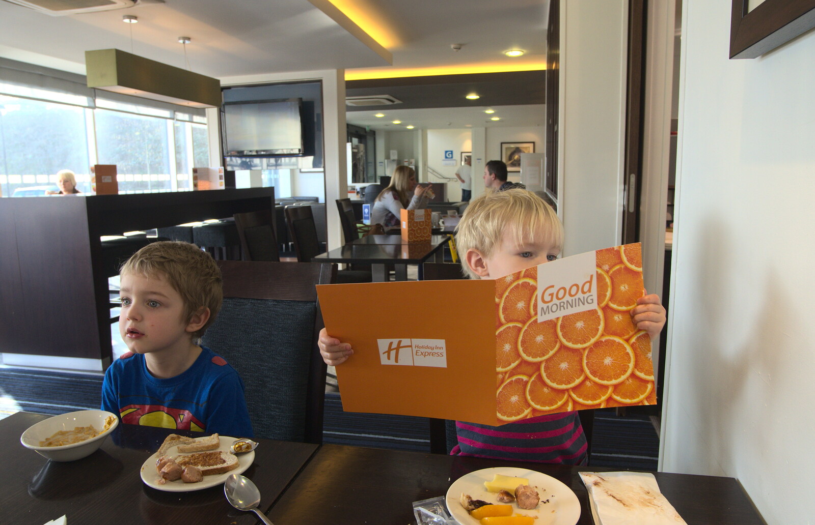 Harry checks out the breakfast menu at the Hotel from A Day Out at Duxford, Cambridgeshire - 9th March 2014