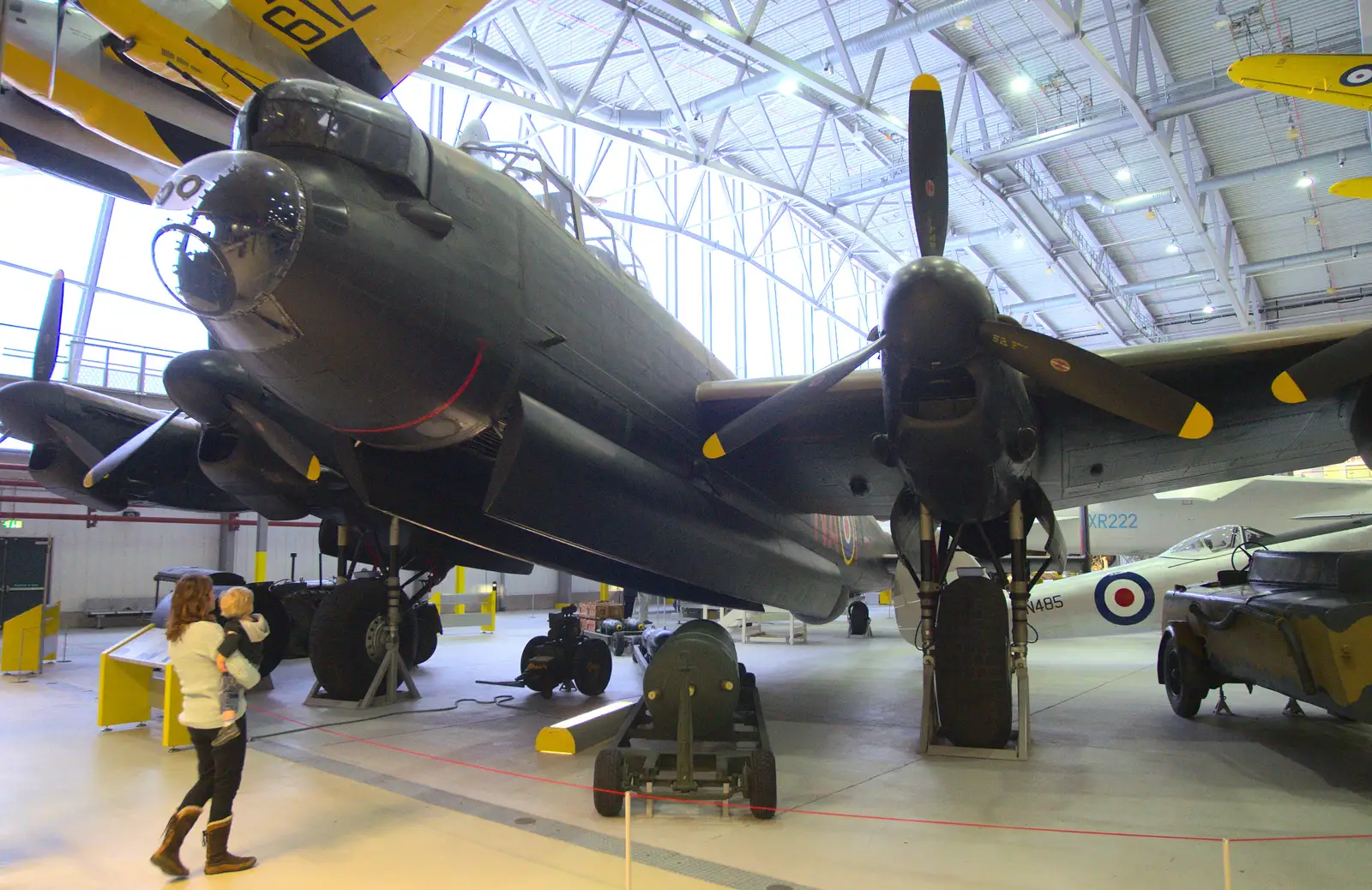 Isobel and Harry under a mighty Lancaster bomber, from A Day Out at Duxford, Cambridgeshire - 9th March 2014