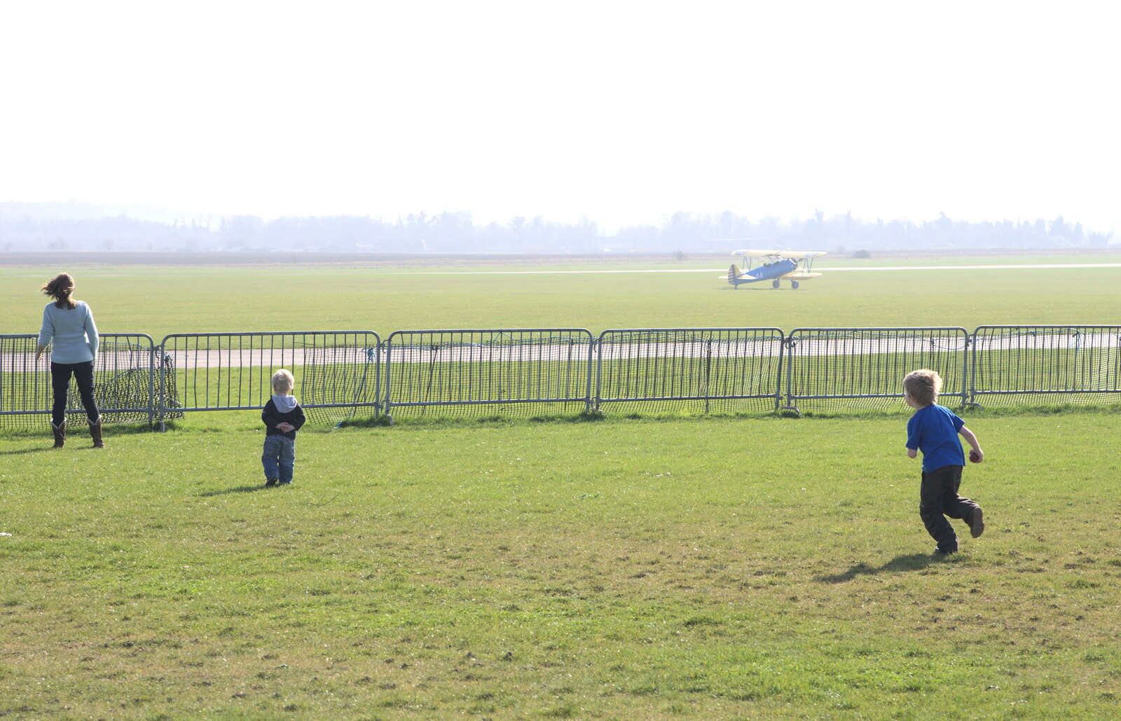 The Stearman lands as Fred runs around from A Day Out at Duxford, Cambridgeshire - 9th March 2014