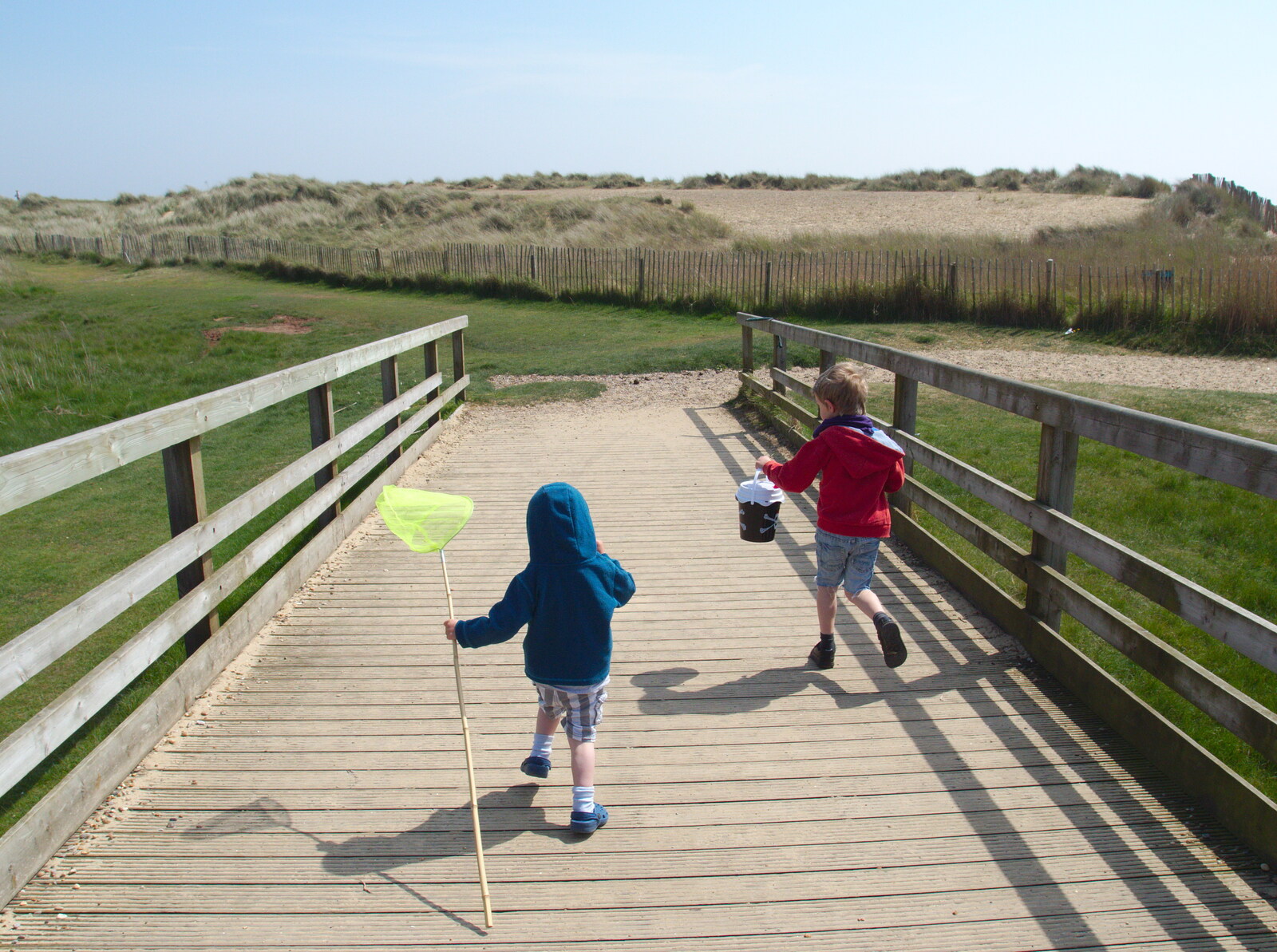 Harry and Fred run ocross the bridge from Life's A Windy Beach, Walberswick, Suffolk - 5th May 2014
