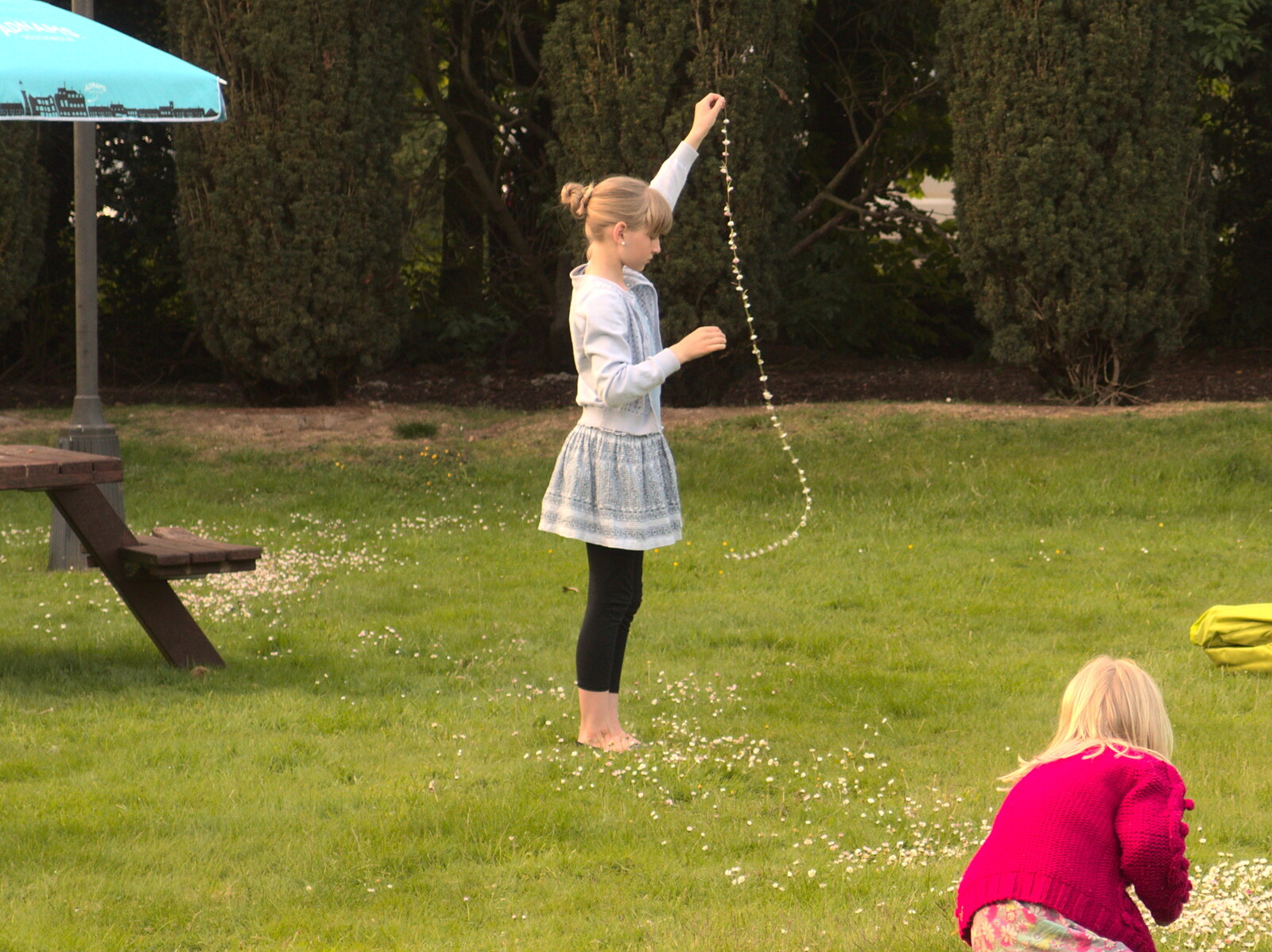 A girl has made a very long daisy chain from Thornham Four Horseshoes, and the Oaksmere, Brome, Suffolk - 17th May 2014