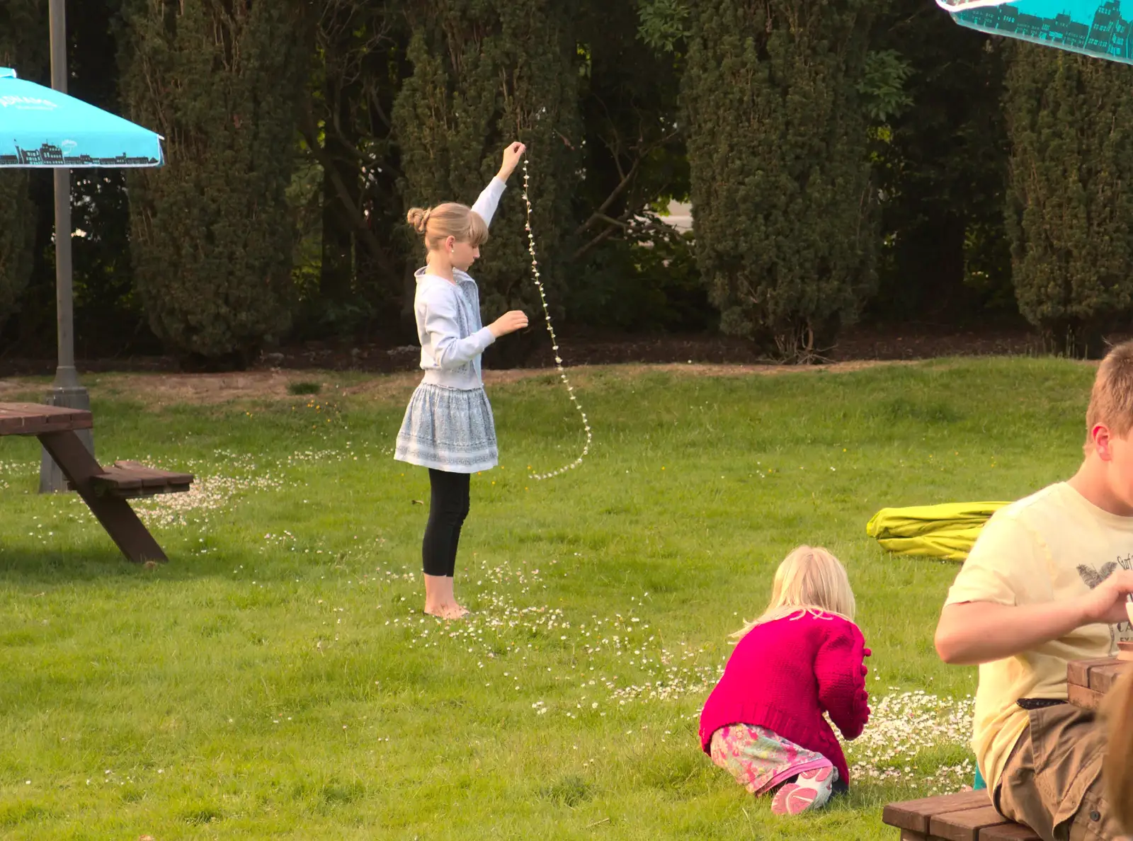 A girl has made a very long daisy chain, from Thornham Four Horseshoes, and the Oaksmere, Brome, Suffolk - 17th May 2014