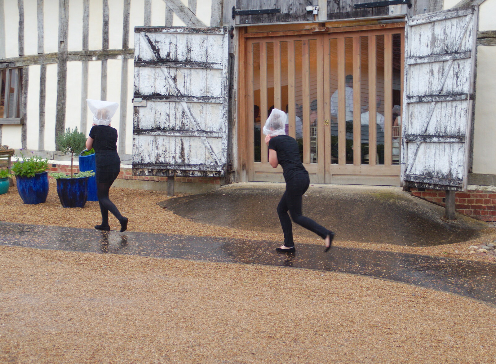 Outside, some waitresses leg it in the rain from The BBs Play Scrabble at Wingfield Barns, Wingfield, Suffolk - 24th May 2014