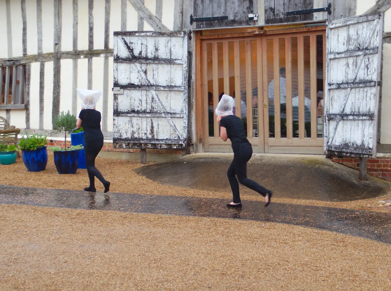 Outside, some waitresses leg it in the rain, from The BBs Play Scrabble at Wingfield Barns, Wingfield, Suffolk - 24th May 2014