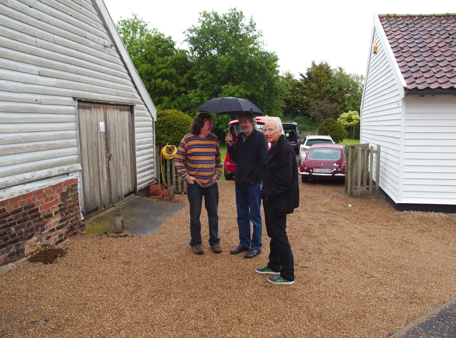 Max and Rob hide under an umbrella, from The BBs Play Scrabble at Wingfield Barns, Wingfield, Suffolk - 24th May 2014