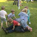 The children all pile onto Mikey P, A "Not a Birthday Party" Barbeque, Brome, Suffolk - 25th May 2014