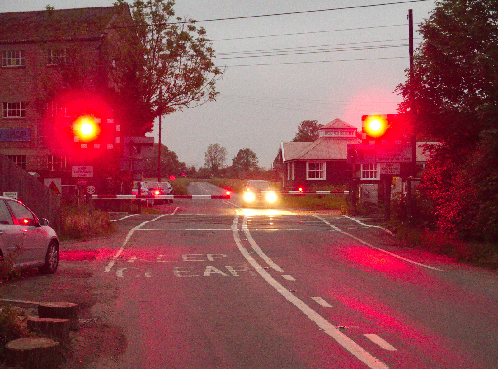 The BSCC at the Railway Tavern, Mellis, Suffolk - 28th May 2014: Traffic waits for an oncoming train