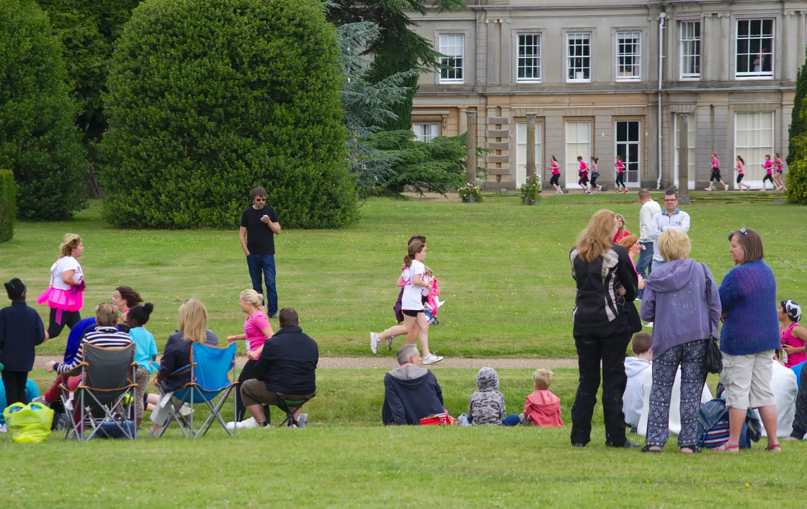 The first runners appear in front of the house, from Isobel's Race For Life, Chantry Park, Ipswich - 11th June 2014