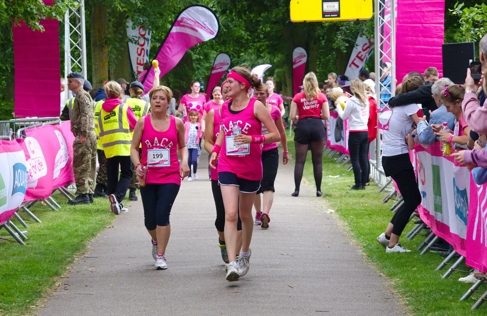 Isobel and the SW Ladies cross the line, from Isobel's Race For Life, Chantry Park, Ipswich - 11th June 2014