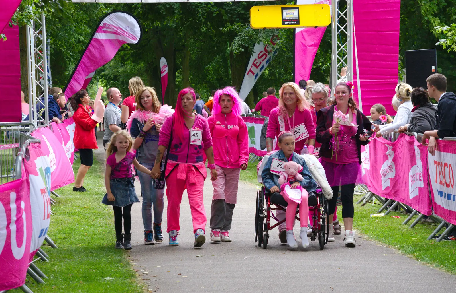 More walkers cross the line, from Isobel's Race For Life, Chantry Park, Ipswich - 11th June 2014