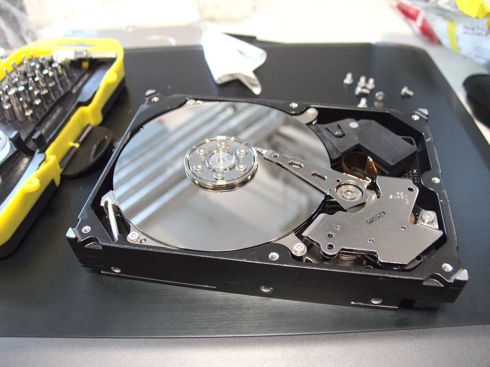 Nosher starts to dis-assemble a 750G hard drive from SwiftKey Innovation Days, The Haymarket, London - 27th June 2014