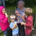 Everyone shelters under an umbrella, The Village Summer Fête, Brome, Suffolk - 5th July 2014