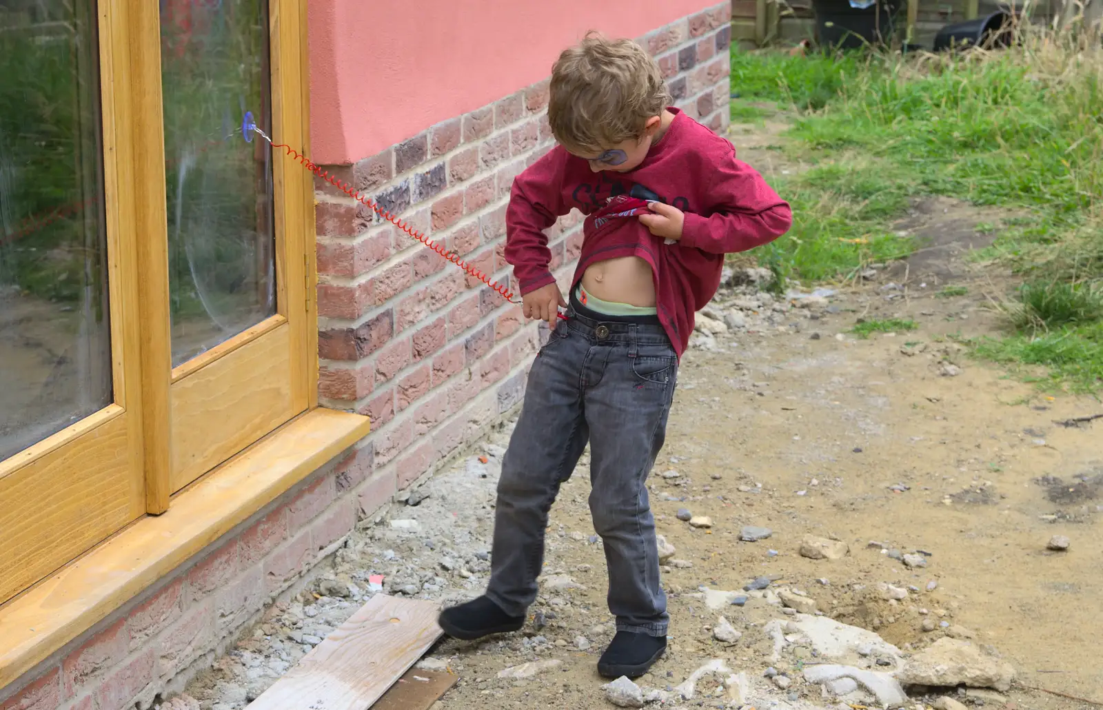 Fred plugs his sucker/coiley-wire thing to the window, from The Village Summer Fête, Brome, Suffolk - 5th July 2014