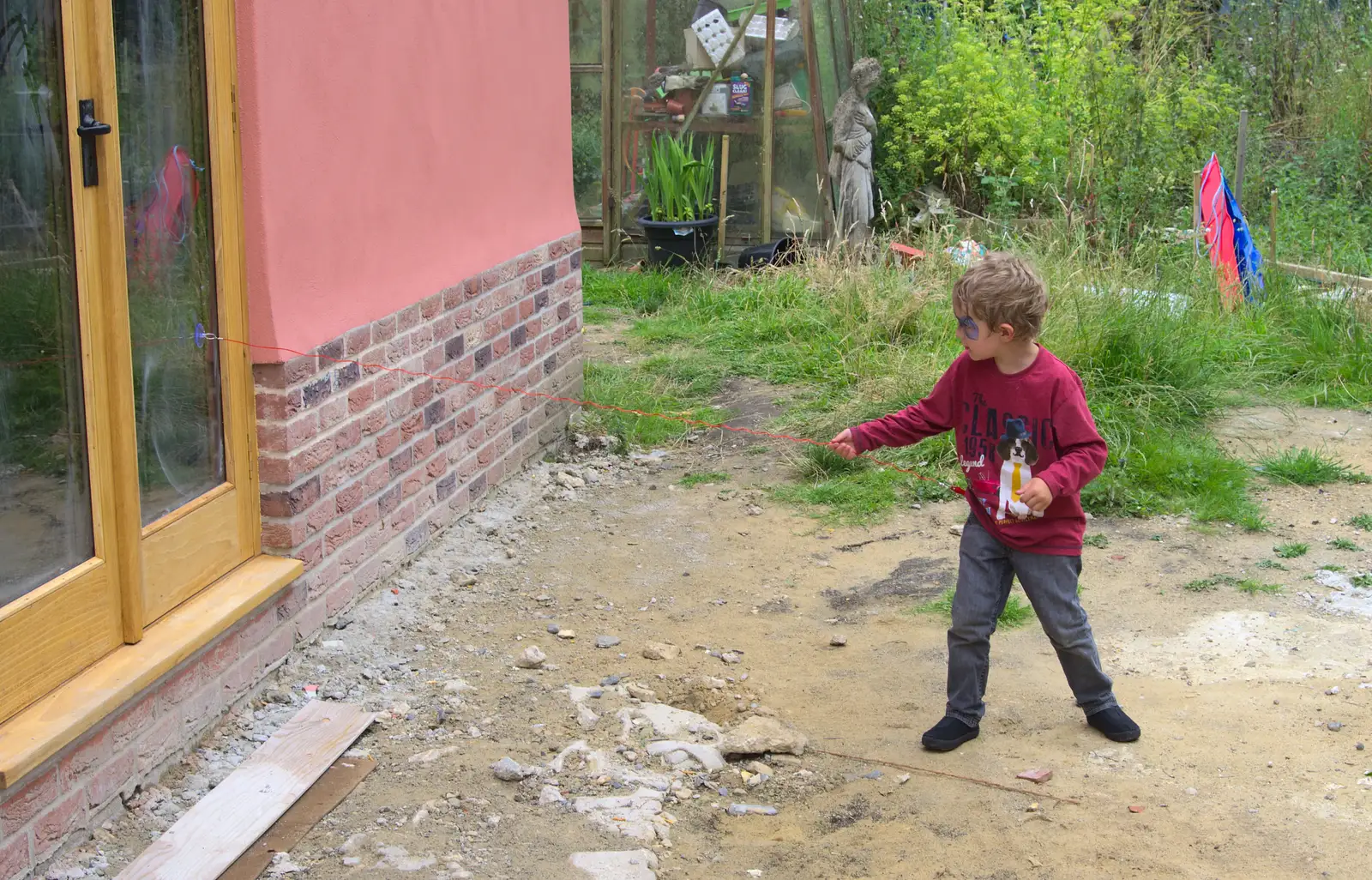 Fred sees how far his coiley thing will stretch, from The Village Summer Fête, Brome, Suffolk - 5th July 2014