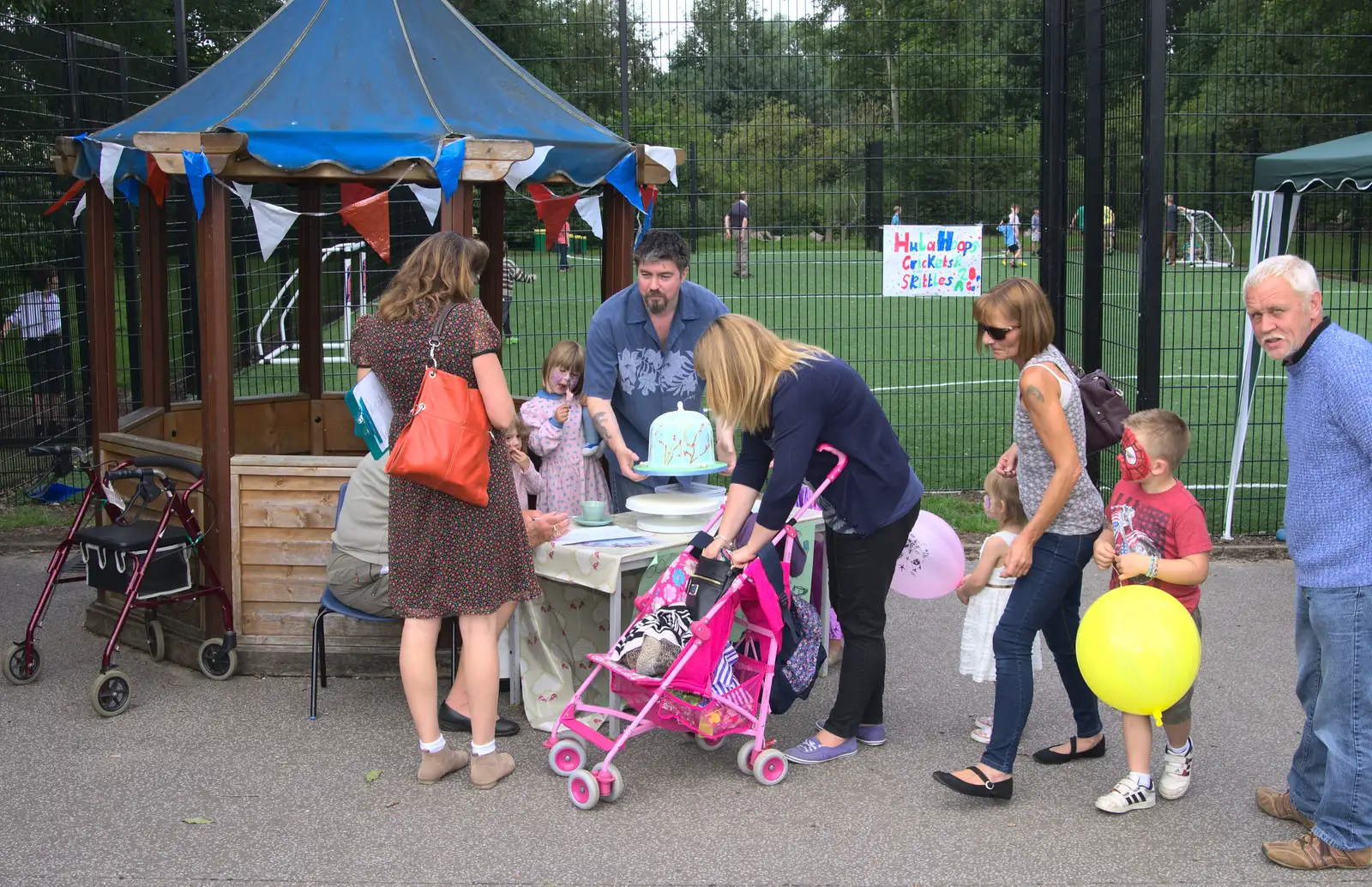 Alex lifts a massive cake, from St. Peter and St. Paul's School Summer Fete, Eye, Suffolk - 12th July 2014