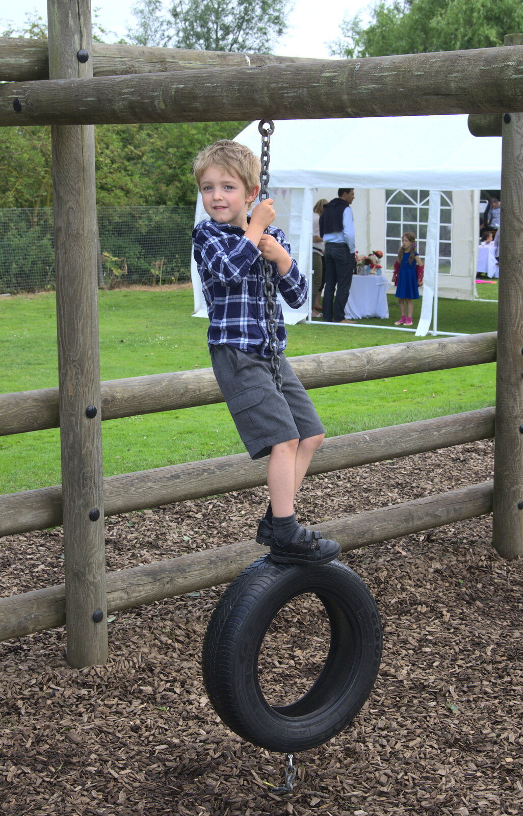 Fred swings about on a tyre from St. Peter and St. Paul's School Summer Fete, Eye, Suffolk - 12th July 2014