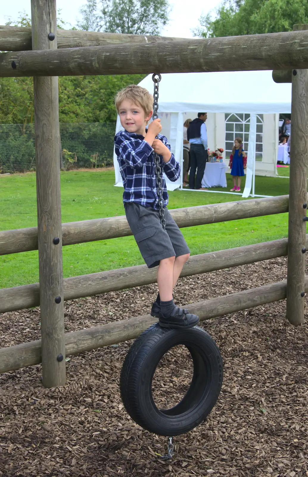 Fred swings about on a tyre, from St. Peter and St. Paul's School Summer Fete, Eye, Suffolk - 12th July 2014