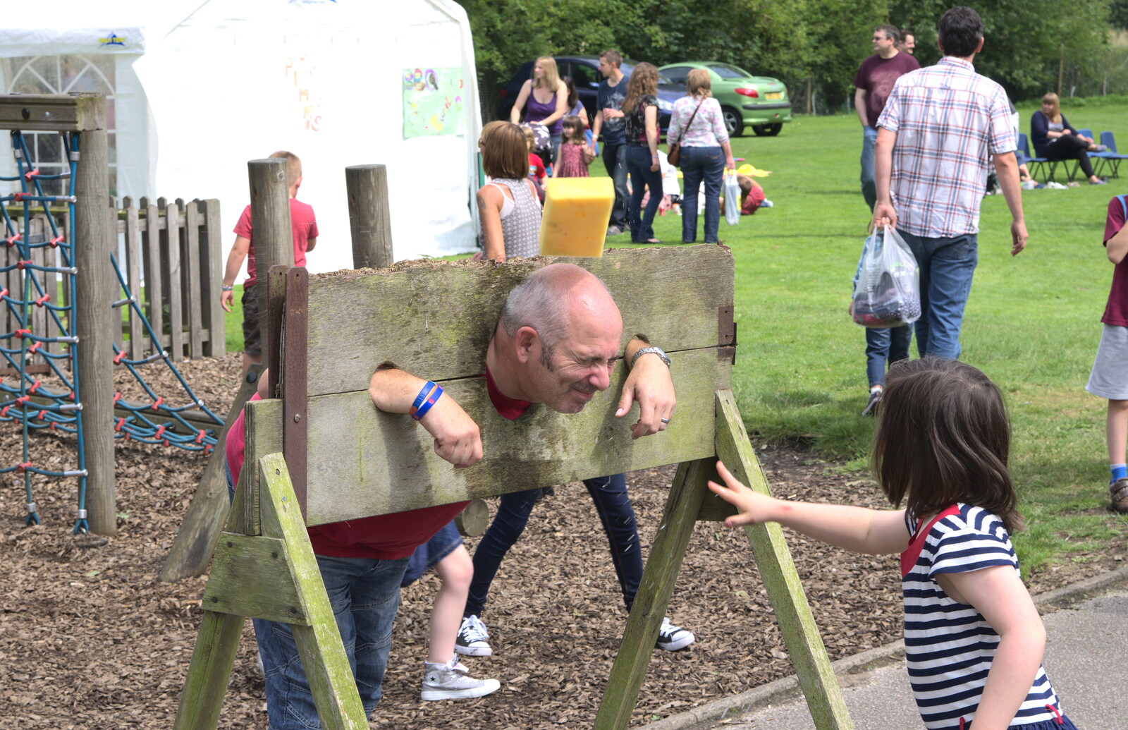 Mr Beckley the caretaker is in the stocks from St. Peter and St. Paul's School Summer Fete, Eye, Suffolk - 12th July 2014