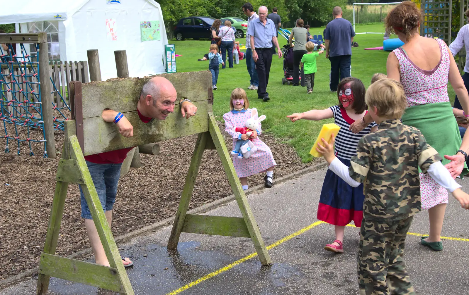 Mr Beckley the caretaker is in the stocks, from St. Peter and St. Paul's School Summer Fete, Eye, Suffolk - 12th July 2014