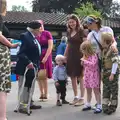 Harry rolls his trouser leg up as Alan King judges, St. Peter and St. Paul's School Summer Fete, Eye, Suffolk - 12th July 2014