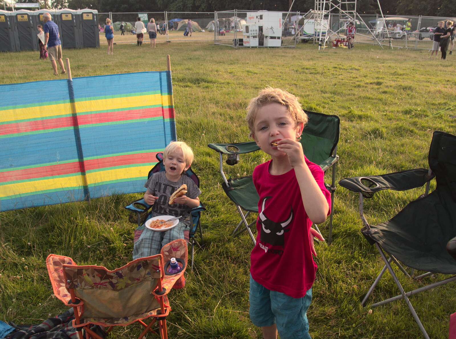 Fred and Harry settle in by eating from Latitude Festival, Henham Park, Southwold, Suffolk - 17th July 2014