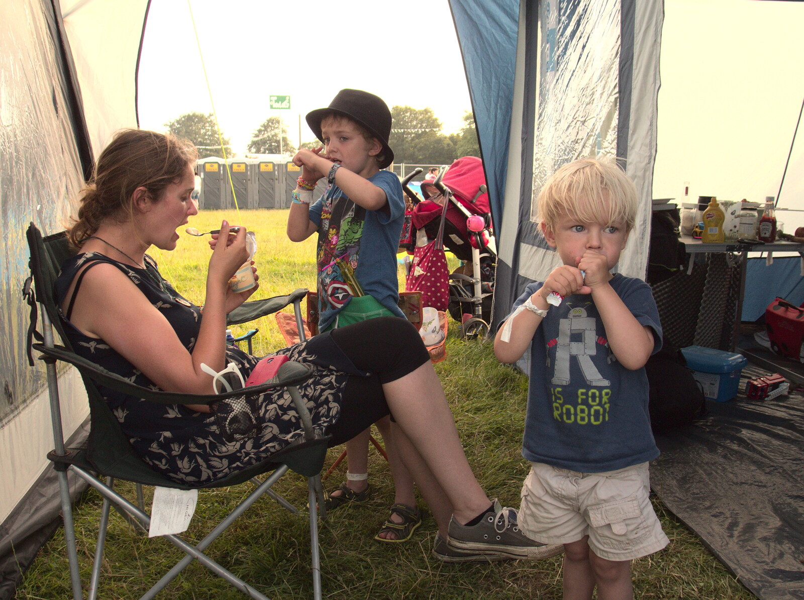 The boys eat squeezy yoghurts back at the tent from Latitude Festival, Henham Park, Southwold, Suffolk - 17th July 2014
