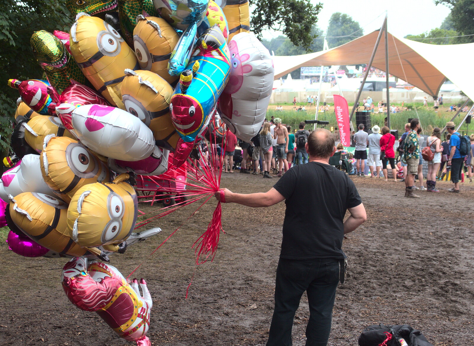 A bloke hauls balloons around from Latitude Festival, Henham Park, Southwold, Suffolk - 17th July 2014