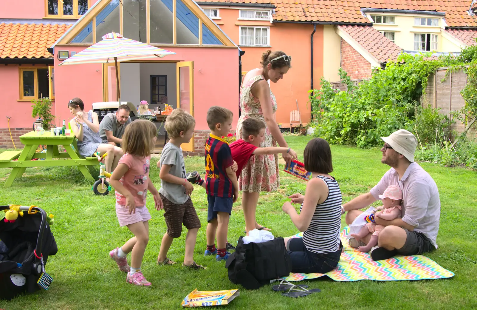 The children rapidly form a queue when sweets appear, from The BSCC at Harleston, and a Visit From Cambridge, Brome, Suffolk - 31st July 2014