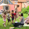 The children rapidly form a queue when sweets appear, The BSCC at Harleston, and a Visit From Cambridge, Brome, Suffolk - 31st July 2014