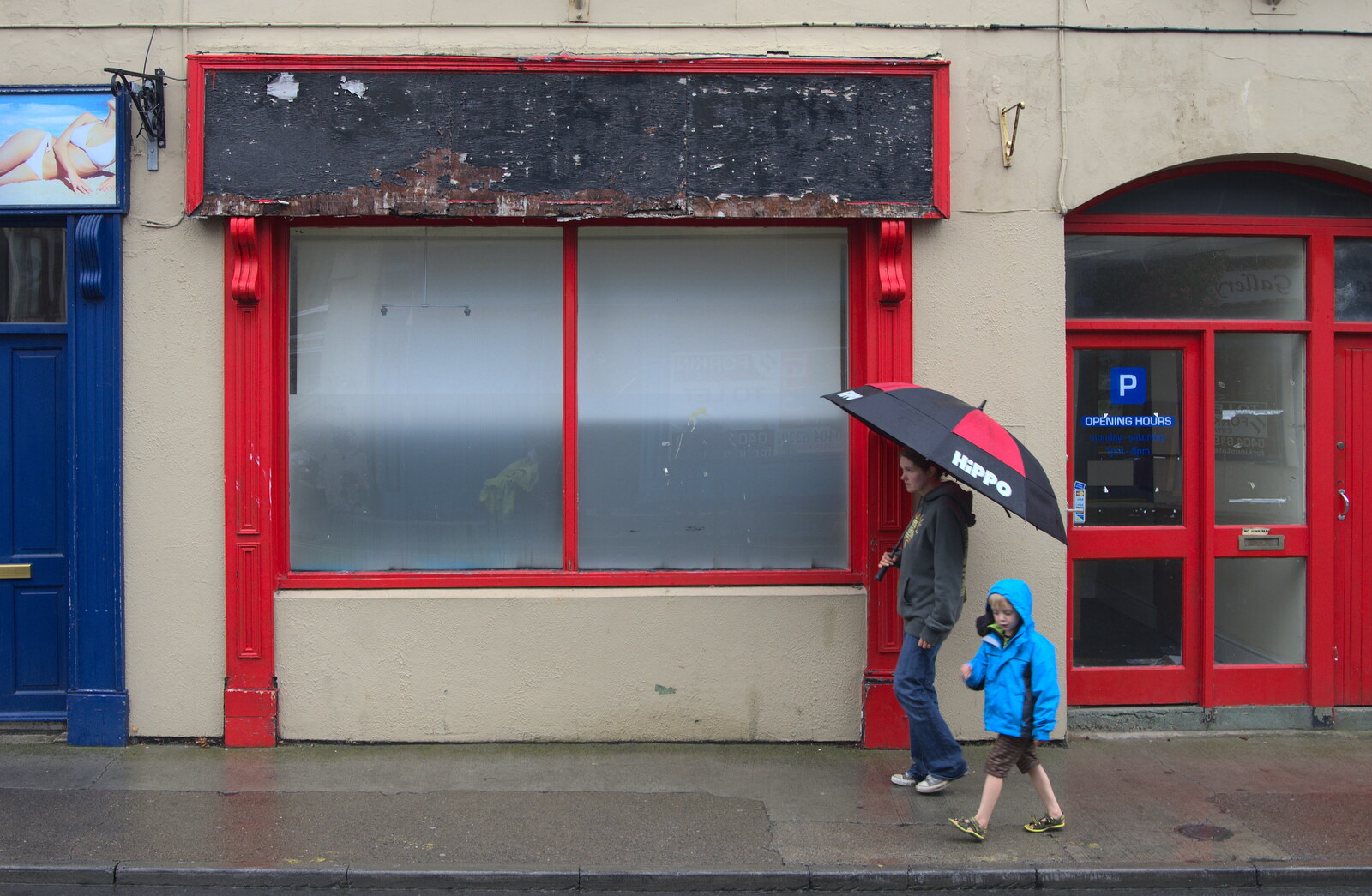 Isobel and Fred walk past an empty shop from Camping at Silver Strand, Wicklow, County Wicklow, Ireland - 7th August 2014
