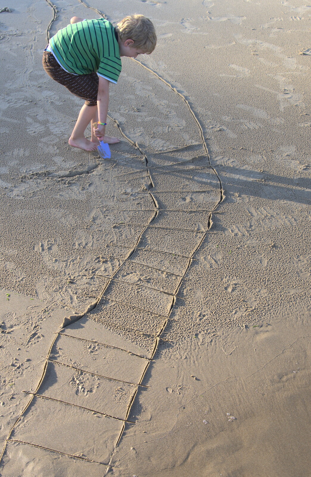Fred draws some sort of ladder in the sand from Camping at Silver Strand, Wicklow, County Wicklow, Ireland - 7th August 2014