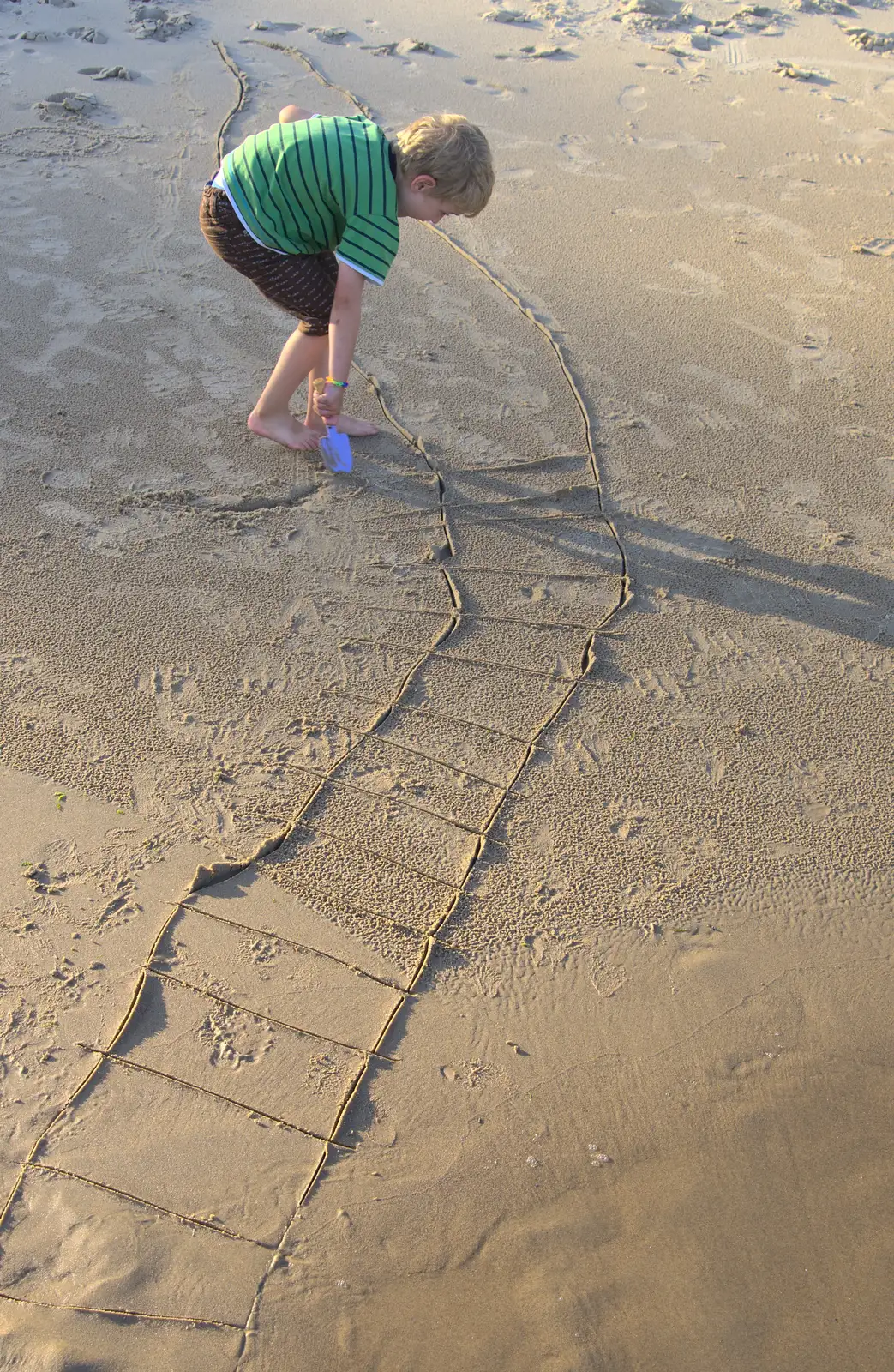 Fred draws some sort of ladder in the sand, from Camping at Silver Strand, Wicklow, County Wicklow, Ireland - 7th August 2014