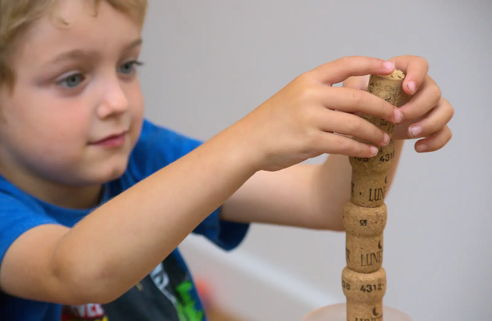 Fred builds a cork pile, from Matthew's Birthday up The Swan Inn, Brome, Suffolk - 17th August 2014