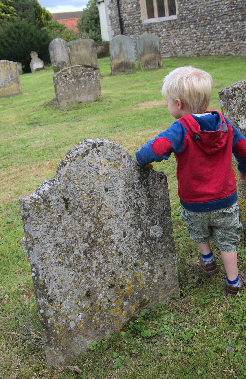 Harry leans on a gravestone from The Oaksmere, and the Gislingham Flower Festival, Suffolk - 24th August 2014