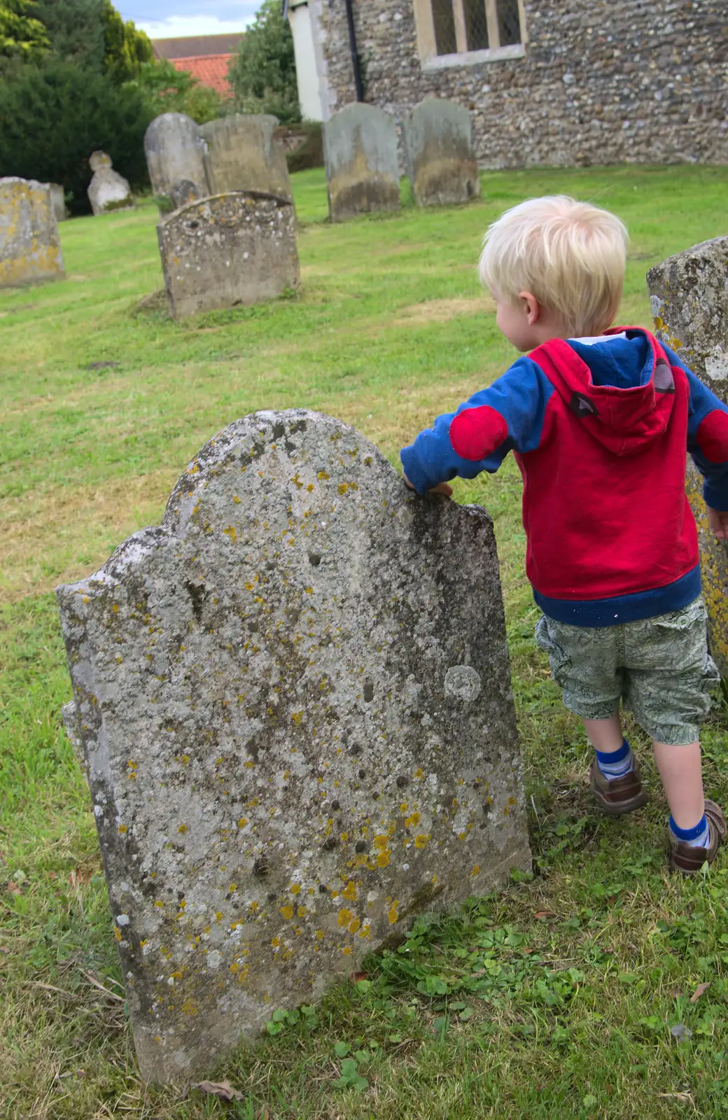 Harry leans on a gravestone, from The Oaksmere, and the Gislingham Flower Festival, Suffolk - 24th August 2014