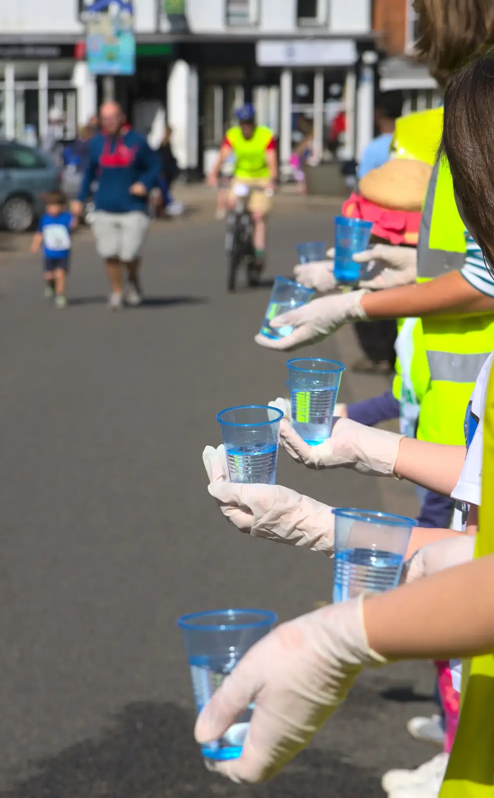 Cups of water are offered up, from The Framlingham 10k Run, Suffolk - 31st August 2014