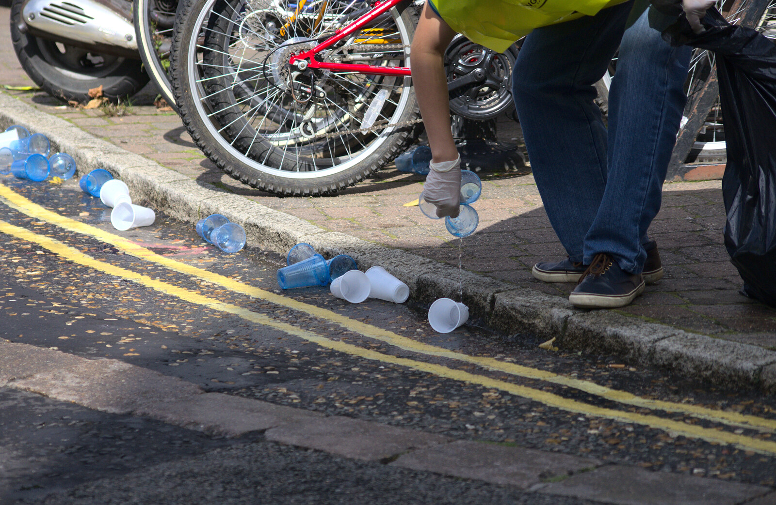 Discarded plastic cups are picked up from The Framlingham 10k Run, Suffolk - 31st August 2014