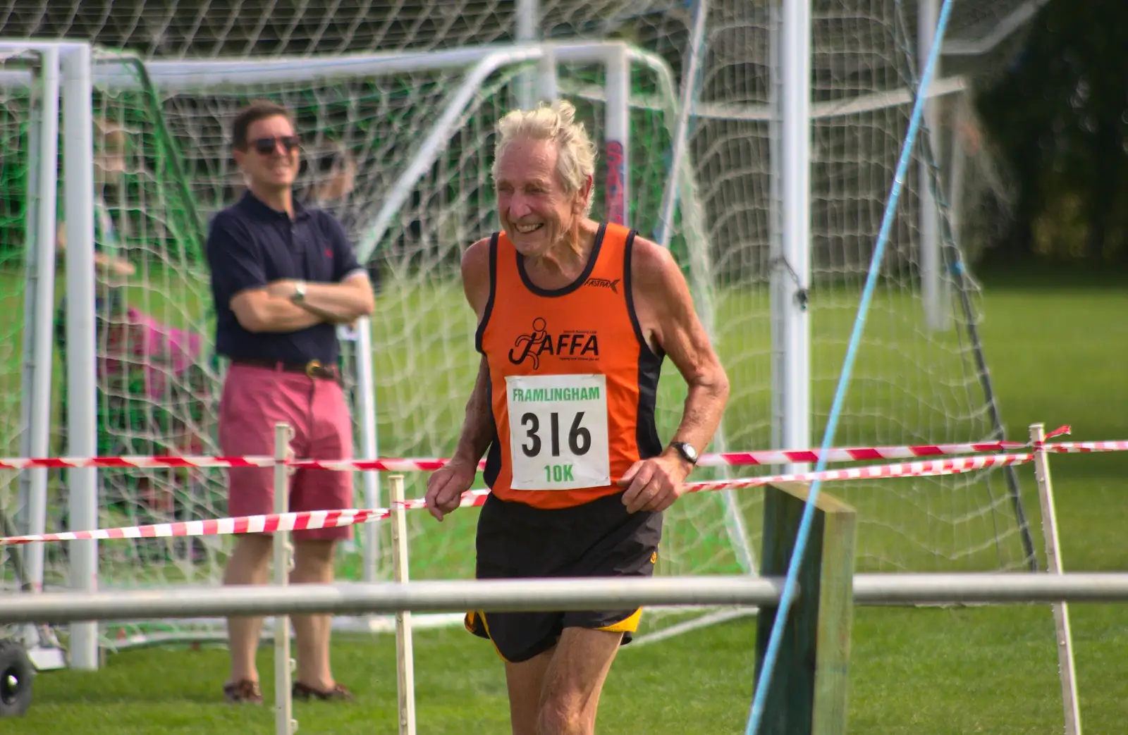 One of the oldest runners crosses the line, from The Framlingham 10k Run, Suffolk - 31st August 2014