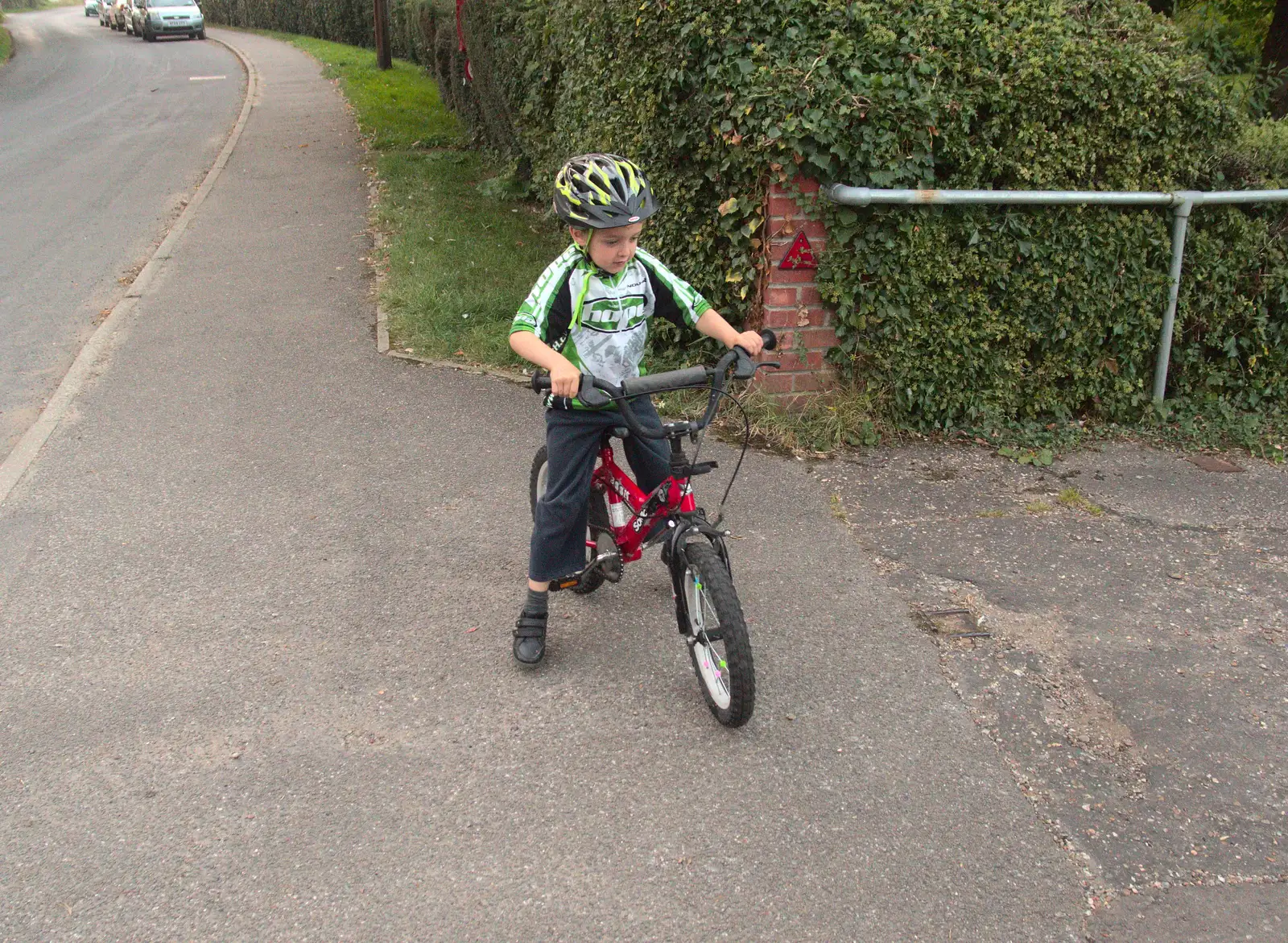 Fred pauses at the Village Hall, from Bike Rides and the BSCC at the Railway, Mellis and Brome, Suffolk - 18th September 2014